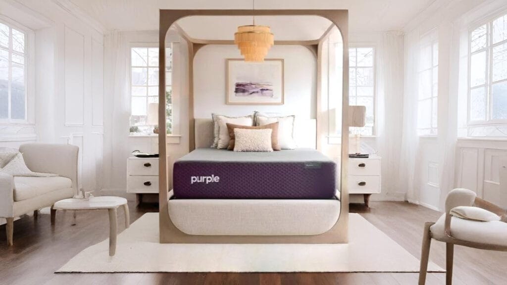 Purple Restore Premier mattress on a modern four-poster bed in a bright, stylish bedroom.